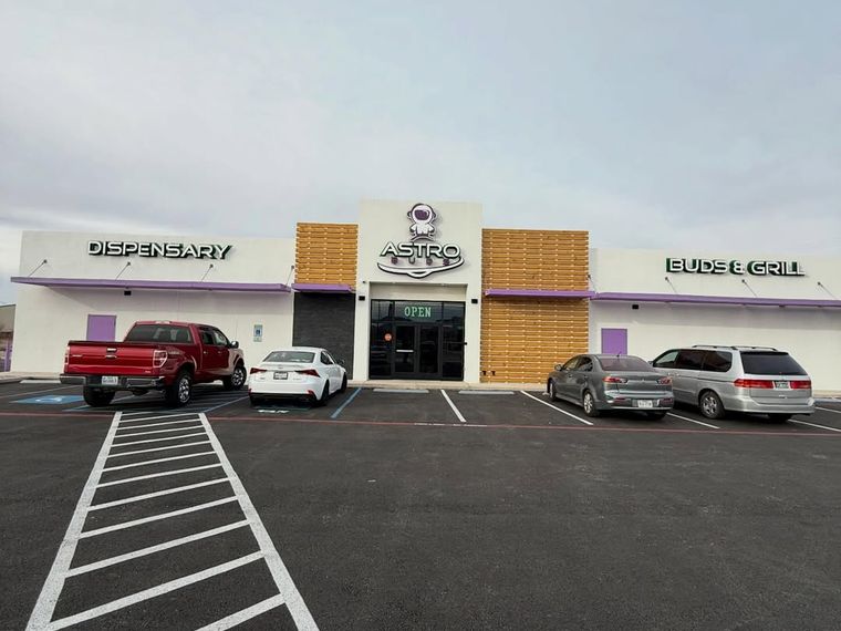 Full frontage of Astro Buds dispensary showing tinted entry glass, El Paso — PMT Tint