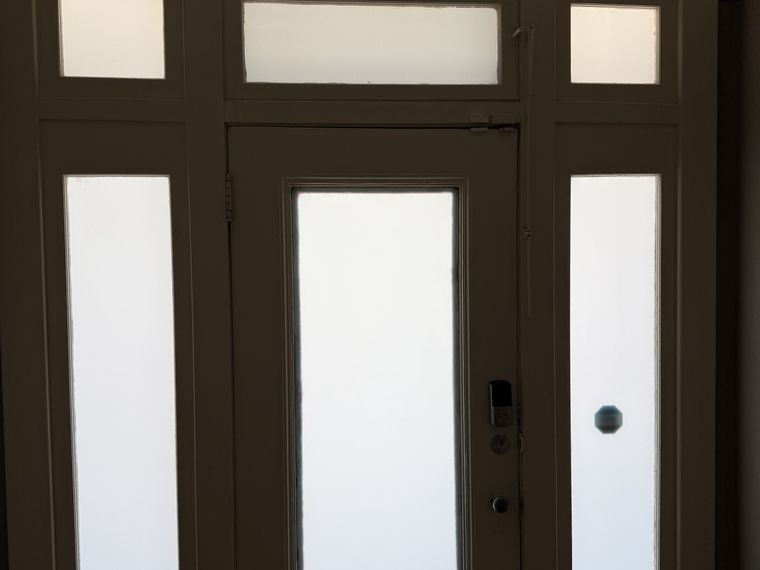 White frost privacy film on a law office entry door and sidelights in El Paso — PMT Tint