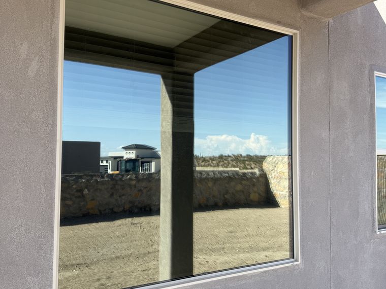 Mirror-finish ceramic film on a residential picture window in El Paso — PMT Tint